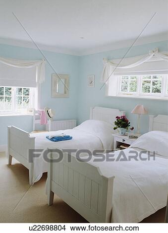 White blinds on windows in pastel turquoise bedrdoom with white linen on white wooden twin beds View Large Photo Image Picture - White blinds on windows in pastel turquoise bedrdoom with white linen on white wooden twin beds. Fotosearch