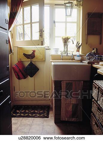 White ceramic Butler's sink beside open stable door in country cottage kitchen View Large Photo Image Stock Photograph - White ceramic Butler's sink beside open stable door in country cottage kitchen. Fotosearch