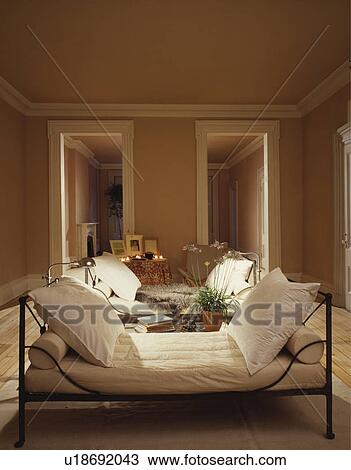 Stock Photo Of White Cushions On Metal Daybed In Uncluttered Living Stock Photo White Cushions On Metal Daybed In Uncluttered Living Room Fotosearch Search