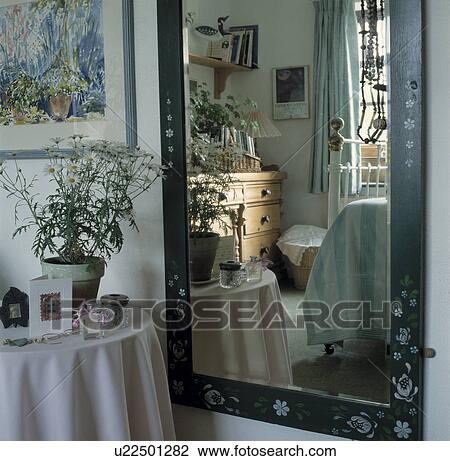 White daisies in pot on circular table with white cloth beside large mirror with reflection of traditional bedroom View Large Photo Image Stock Image - White daisies in pot on circular table with white cloth beside large mirror with reflection of traditional bedroom. Fotosearch