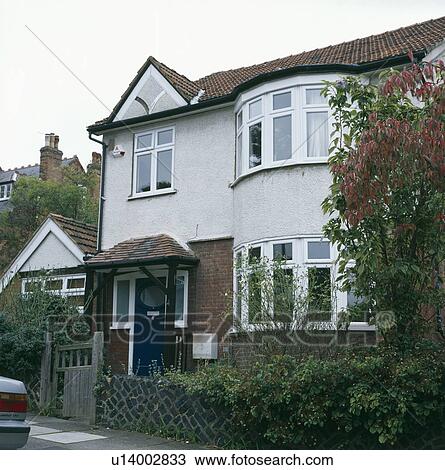 Stock Image - White detached thirties house with bay windows. Fotosearch