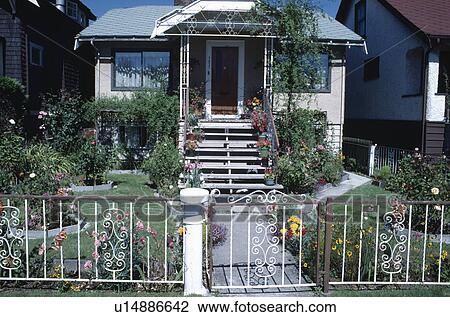 White iron gate and railings in front of garden of small American house with steps up to the front door View Large Photo Image Stock Image - White iron gate and railings in front of garden of small American house with steps up to the front door. Fotosearch