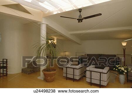 White leather Le Corbusier armchairs in modern white loft conversion living room View Large Photo Image Stock Photo - White leather Le Corbusier armchairs in modern white loft conversion living room. Fotosearch