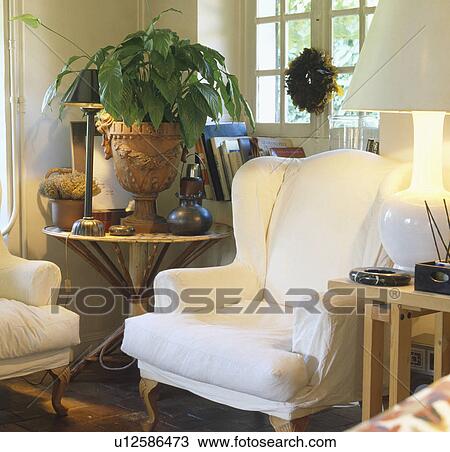 White loosecovers on armchairs in traditional living room View Large Photo Image Stock Image - White loosecovers on armchairs in traditional living room. Fotosearch