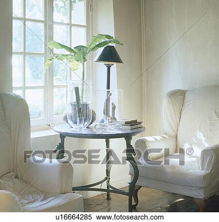 Stock Photography - White loosecovers on armchairs in traditional living room. Fotosearch