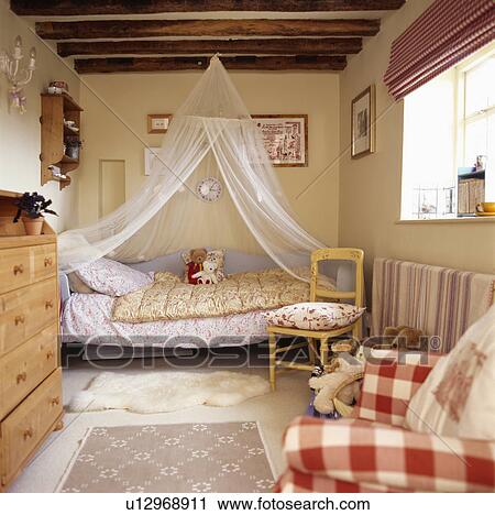 White muslin mosquito bet above bed in child's cottage bedroom View Large Photo Image Stock Image - White muslin mosquito bet above bed in child's cottage bedroom. Fotosearch