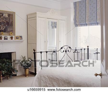 Stock Photography - White painted bedroom with dado picked out in grey.. Fotosearch