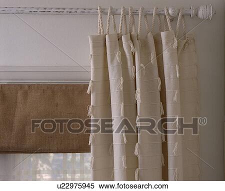 Stock Photography - White painted curtain pole with white cotton curtain and hessian blind . Fotosearch
