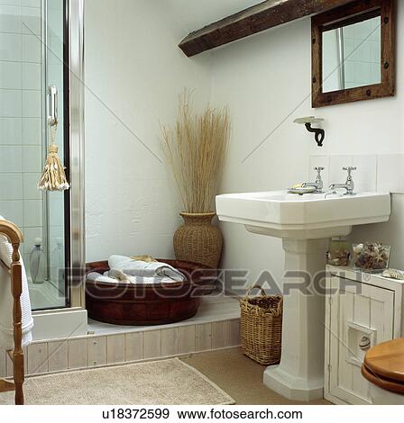 White pedestal basin in country bathroom with towels in large wooden bowl beside shower View Large Photo Image Stock Photo - White pedestal basin in country bathroom with towels in large wooden bowl beside shower. Fotosearch