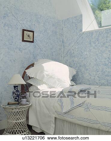 White pillows and blue+white duvet on bed below window in bedroom with painted stippled blue+white walls View Large Photo Image Stock Photograph - White pillows and blue+white duvet on bed below window in bedroom with painted stippled blue+white walls. Fotosearch