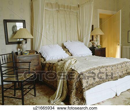 White pillows and patterned throw on antique half-tester bed with cream lace drapes View Large Photo Image Picture - White pillows and patterned throw on antique half-tester bed with cream lace drapes. Fotosearch