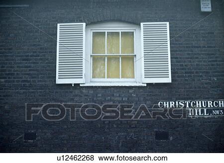 Stock Photo - White shutters on black cottage in Hampstead, North London. Fotosearch