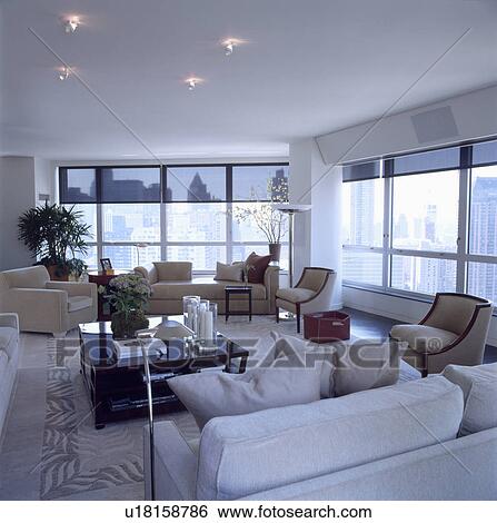 White sofas and cream armchairs in modern white city living room with view of New York View Large Photo Image Stock Photograph - White sofas and cream armchairs in modern white city living room with view of New York. Fotosearch
