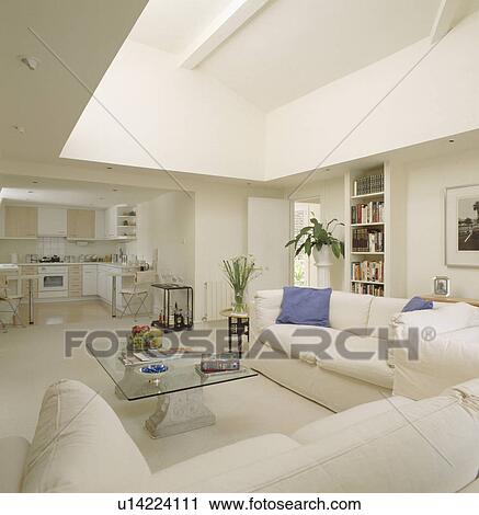 White sofas and glass table in modern openplan apartment in small loft conversion View Large Photo Image Stock Image - White sofas and glass table in modern openplan apartment in small loft conversion. Fotosearch
