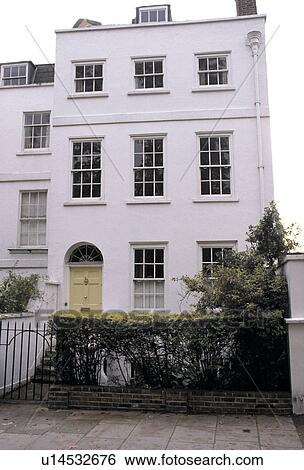 Stock Photograph - White stucco three-storey Regency house in London. Fotosearch