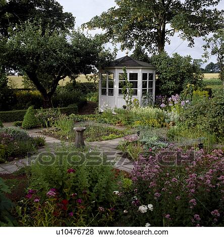 White summerhouse in country vegetable garden with protective netting over vegetables View Large Photo Image Stock Photo - White summerhouse in country vegetable garden with protective netting over vegetables. Fotosearch