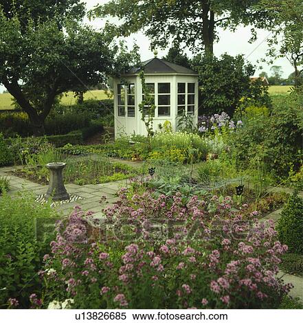 White summerhouse in country vegetable garden with protective netting over vegetables View Large Photo Image Stock Photography - White summerhouse in country vegetable garden with protective netting over vegetables. Fotosearch