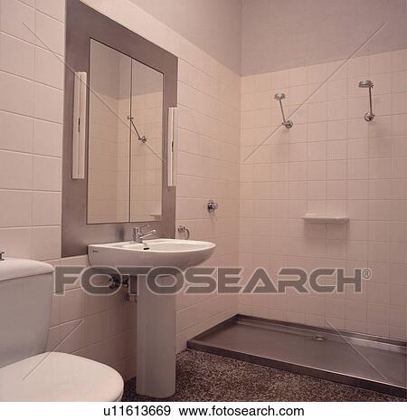 Stock Photo - White tiled architectural bathroom with open shower and grey paintwork.. Fotosearch