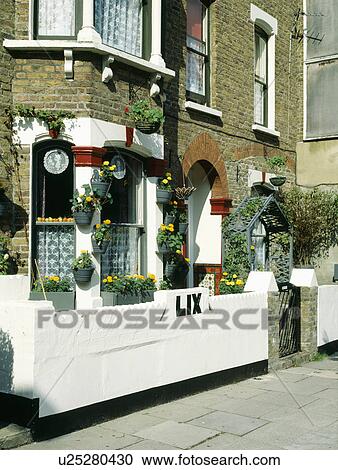 White wall in front of Victorian terraced townhouse with yellow tagetes in pots on bay window View Large Photo Image Stock Image - White wall in front of Victorian terraced townhouse with yellow tagetes in pots on bay window. Fotosearch