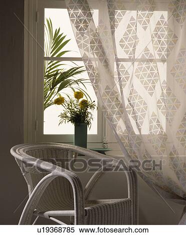 Stock Photography - Wicker chair and voile curtain. Fotosearch
