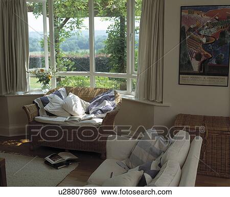Wicker sofa in window of cottage living room View Large Photo Image Stock Photo - Wicker sofa in window of cottage living room. Fotosearch