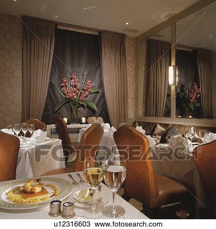 Wine glasses and food on tables with white cloths in traditional hotel dining room View Large Photo Image Stock Image - Wine glasses and food on tables with white cloths in traditional hotel dining room. Fotosearch