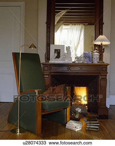 Wood-framed armchair beside fireplace View Large Photo Image Stock Image - Wood-framed armchair beside fireplace. Fotosearch