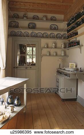 Stock Photography - Wooden floor in country kitchen with shelving and wooden floor. Fotosearch
