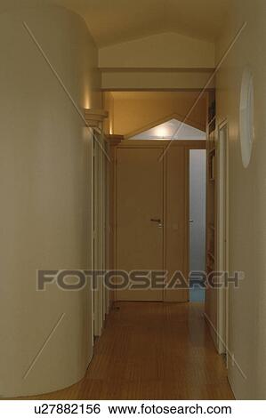 Stock Photograph - Wooden floor in narrow white hall. Fotosearch
