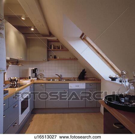Wooden Flooring And Blue Grey Fitted Cupboards In Modern White