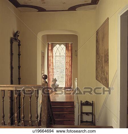Wooden stairs and bannisters on staircase with window above small wooden landing View Large Photo Image Picture - Wooden stairs and bannisters on staircase with window above small wooden landing. Fotosearch