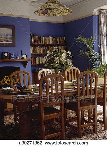 Wooden table and chairs in bright blue dining room View Large Photo Image Stock Image - Wooden table and chairs in bright blue dining room. Fotosearch