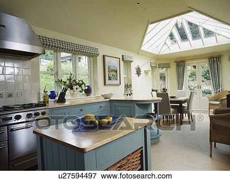 Wooden worktop on island unit in cream kitchen dining room extension with turquoise cupboards and cream flooring View Large Photo Image Stock Photo - Wooden worktop on island unit in cream kitchen dining room extension with turquoise cupboards and cream flooring. Fotosearch