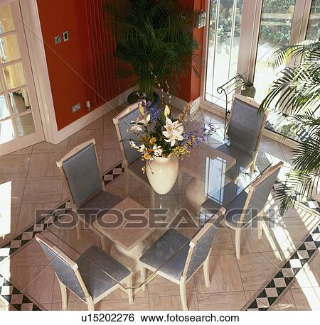 Aerial view of glass table and grey chairs in red dining room with tiled floor View Large Photo Image Stock Photograph - Aerial view of glass table and grey chairs in red dining room with tiled floor. Fotosearch