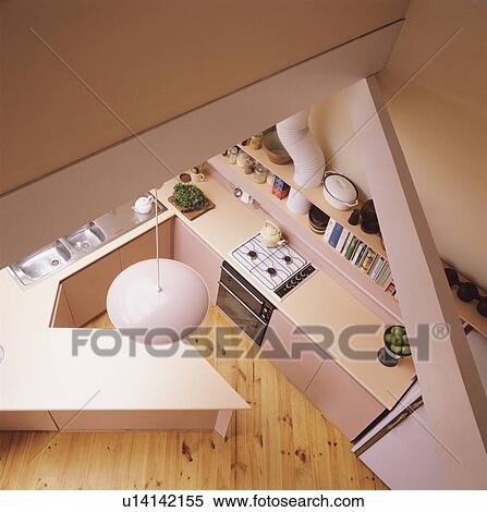 Stock Photography - Aerial view of modern pastel pink kitchen with wooden flooring. Fotosearch