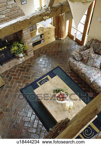 Aerial view of pine table on herringbone pattern reclaimed brick floor in country living room View Large Photo Image Picture - Aerial view of pine table on herringbone pattern reclaimed brick floor in country living room. Fotosearch