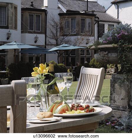 Stock Image - Alfresco eating at country hotel in summer.. Fotosearch
