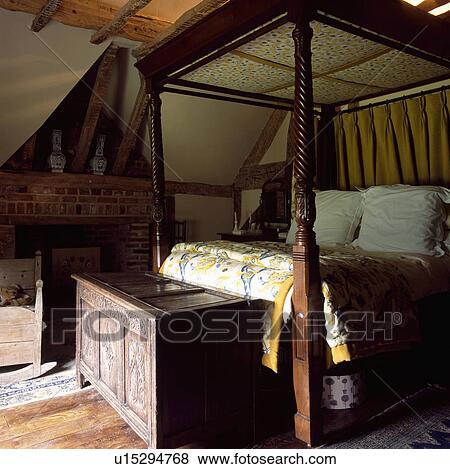 Antique carved wood four-poster bed and chest in country bedroom View Large Photo Image Stock Photo - Antique carved wood four-poster bed and chest in country bedroom. Fotosearch