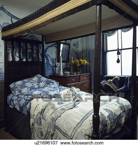 Antique four-poster bed with blue+white pillows and duvet and embroidered blue+white linen bedcover View Large Photo Image Stock Photo - Antique four-poster bed with blue+white pillows and duvet and embroidered blue+white linen bedcover. Fotosearch