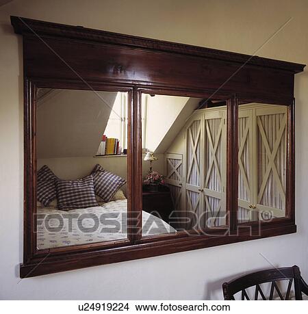 Antique mahogany mirror with reflection of attic bedroom View Large Photo Image Picture - Antique mahogany mirror with reflection of attic bedroom. Fotosearch