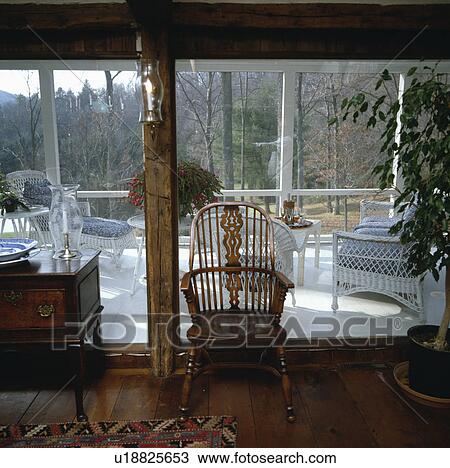 Antique Windsor chair in front of large window View Large Photo Image Stock Image - Antique Windsor chair in front of large window. Fotosearch