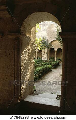 Stock Image - Arched doorway and courtyard of traditional village house in Provence. Fotosearch