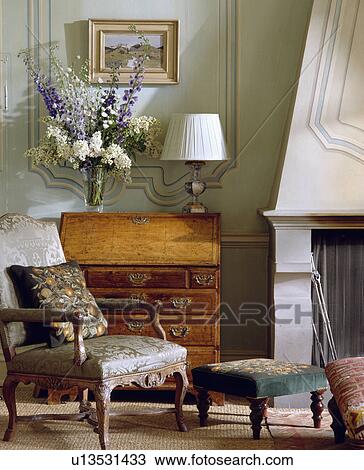 Armchair in front of antique bureau View Large Photo Image Stock Image - Armchair in front of antique bureau. Fotosearch