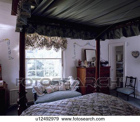 Bedroom With View From Four Poster Bed With Green Drapes To Blue