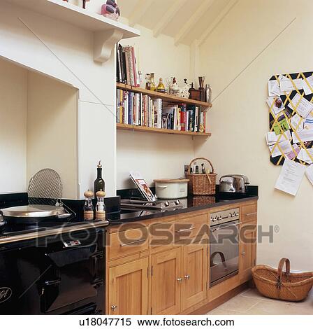 Black Aga in modern kitchen with bookshelves above built-in electric oven View Large Photo Image Stock Photography - Black Aga in modern kitchen with bookshelves above built-in electric oven . Fotosearch