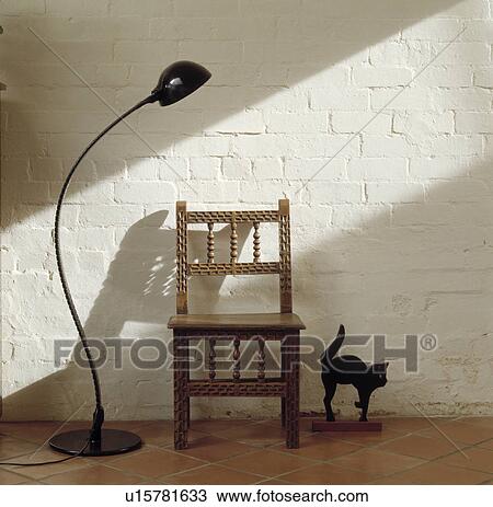 Black floor lamp and carved wooden chair against white painted brick wall View Large Photo Image Stock Image - Black floor lamp and carved wooden chair against white painted brick wall. Fotosearch