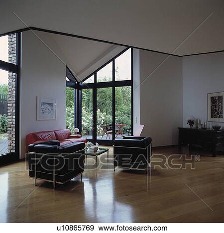 Black leather and chrome Le Corbusier chairs in modern living room with wooden flooring View Large Photo Image Stock Photo - Black leather and chrome Le Corbusier chairs in modern living room with wooden flooring. Fotosearch