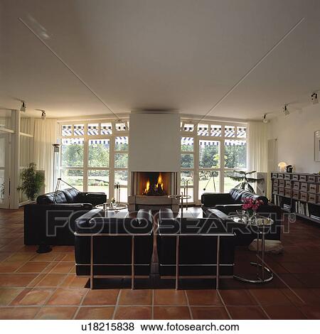 Black leather and chrome Le Corbusier sofas in modern white living room View Large Photo Image Stock Photo - Black leather and chrome Le Corbusier sofas in modern white living room. Fotosearch
