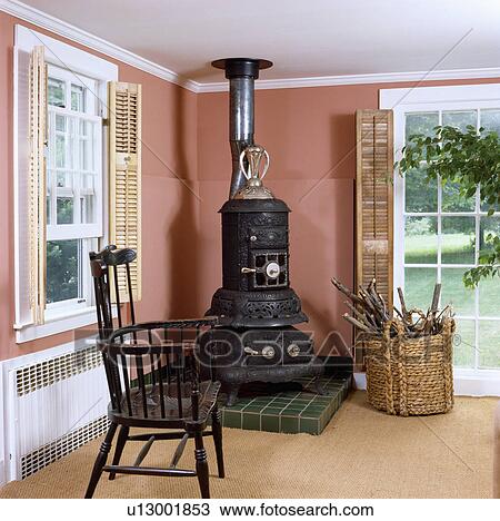 Black stove and antique chair in terracotta country living room View Large Photo Image Stock Image - Black stove and antique chair in terracotta country living room. Fotosearch