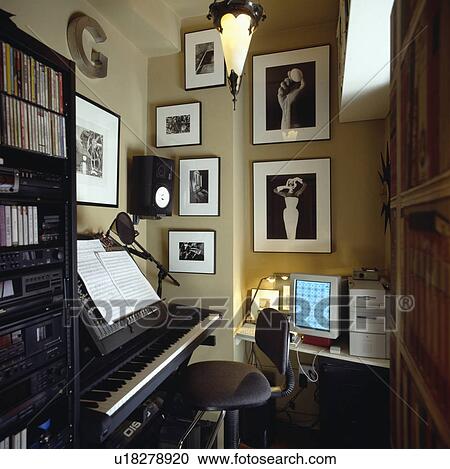 Black+white photographs on wall of small music room study with electric organ View Large Photo Image Stock Image - Black+white photographs on wall of small music room study with electric organ. Fotosearch
